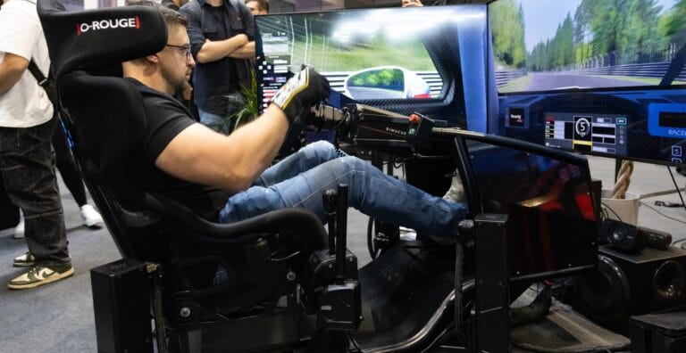 Professional driver Misha Charoudin using Novus racing simulator with direct-drive wheelbase and load-cell pedals