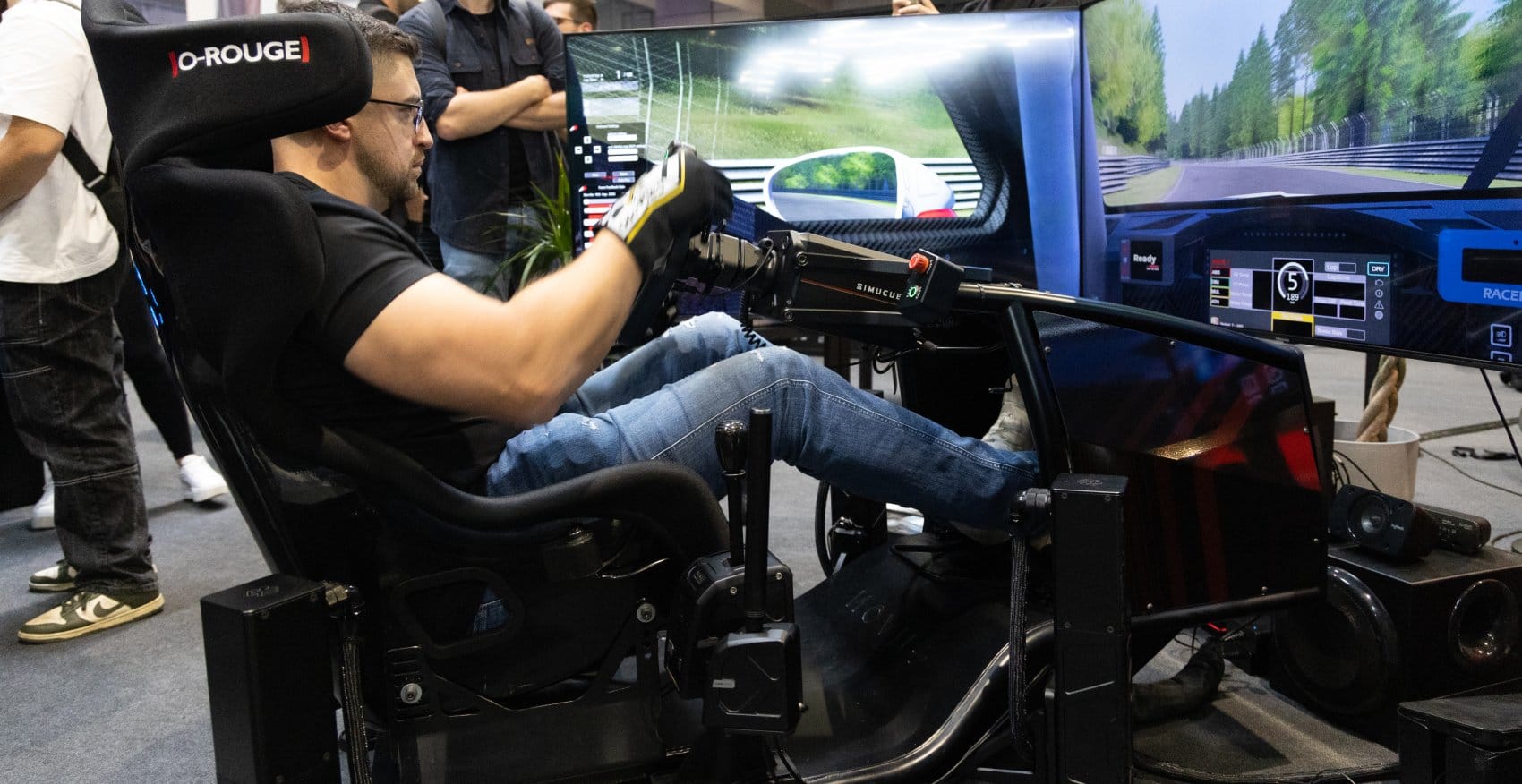 Professional driver Misha Charoudin using Novus racing simulator with direct-drive wheelbase and load-cell pedals