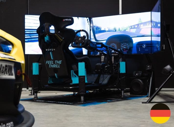 Black and cyan Novus X Cage racing simulator at experience center in Germany for test drives