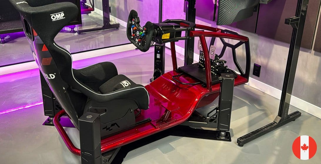Novus Strike racing simulator with red X Cage chassis and triple curved monitors at Canadian partner demo location