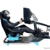 Novus S Cockpit professional sim racing cockpit with driver seated showing VRS components